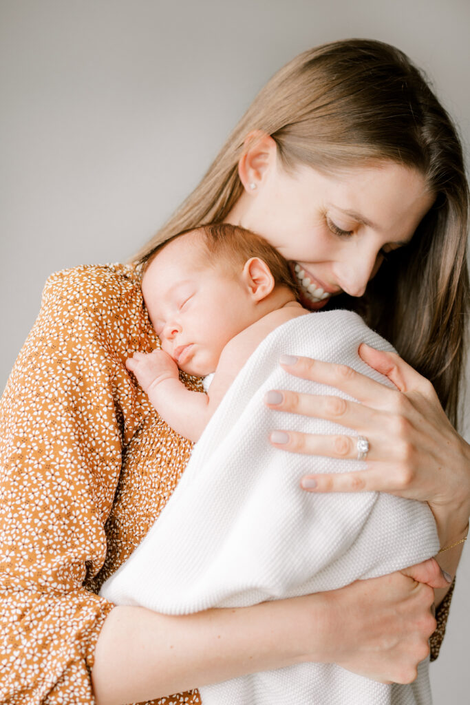 In-Home Newborn Photos - Johns Island Photographer - Mom snuggling newborn baby 