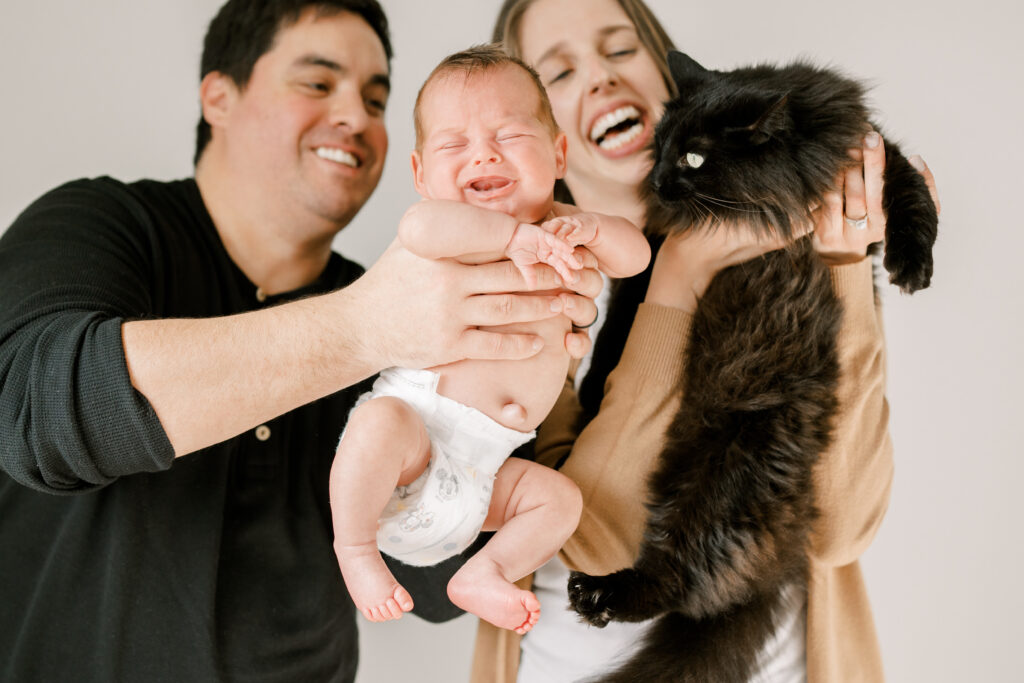 mom and dad being silly during in-home newborn photoshoot with Johns Island Photographer