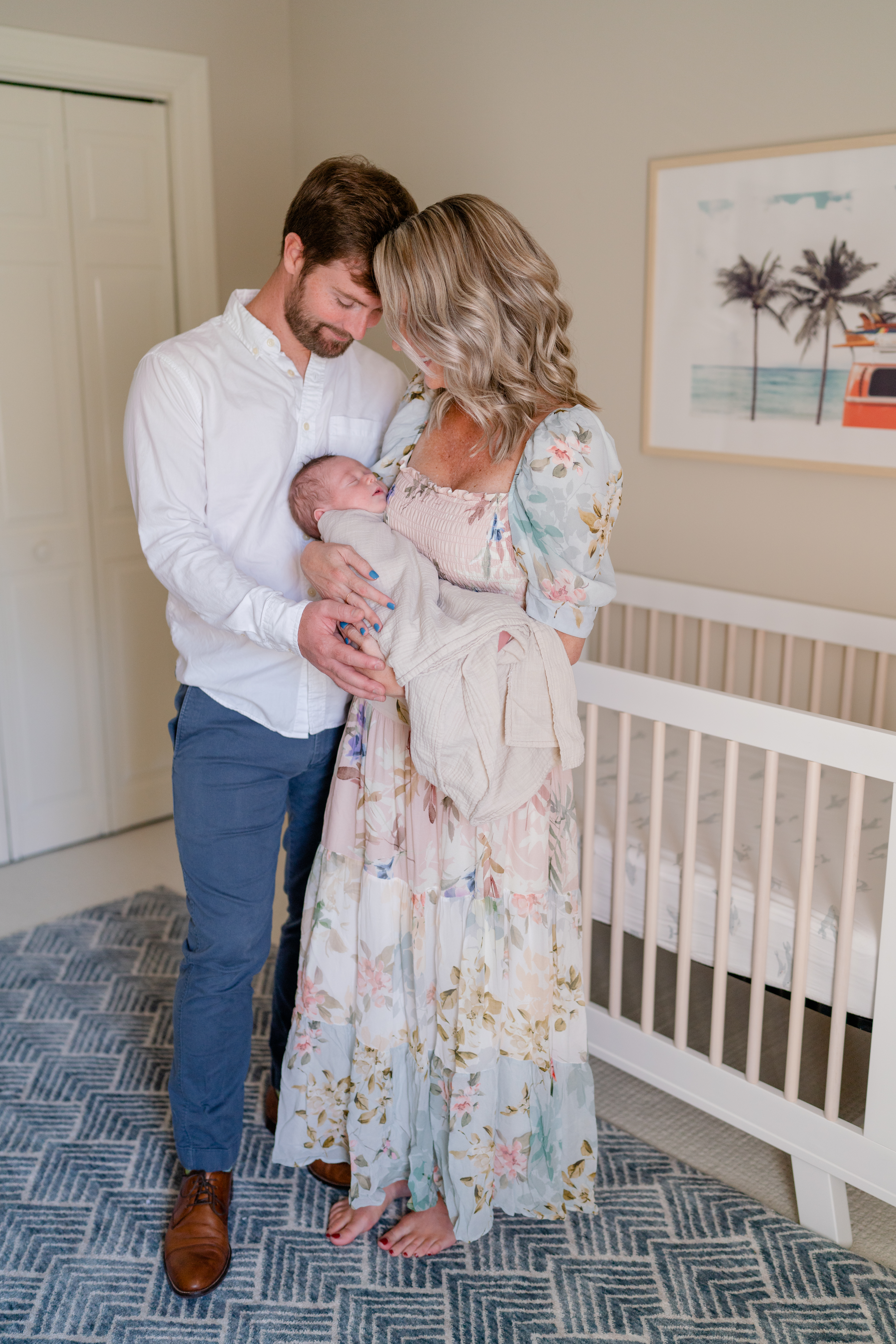 Charleston Newborn Photographer - Mom and dad snuggling newborn baby in nursery