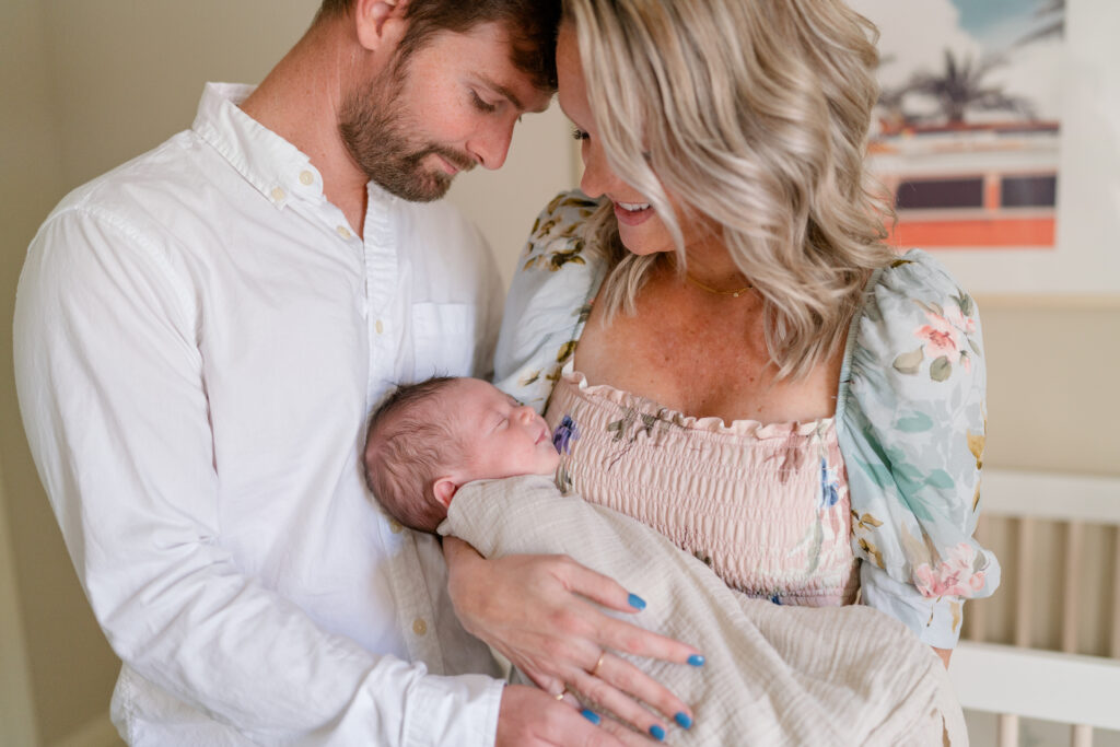 Charleston Newborn Photographer - Close up shot of mom and dad snuggling newborn during photoshoot
